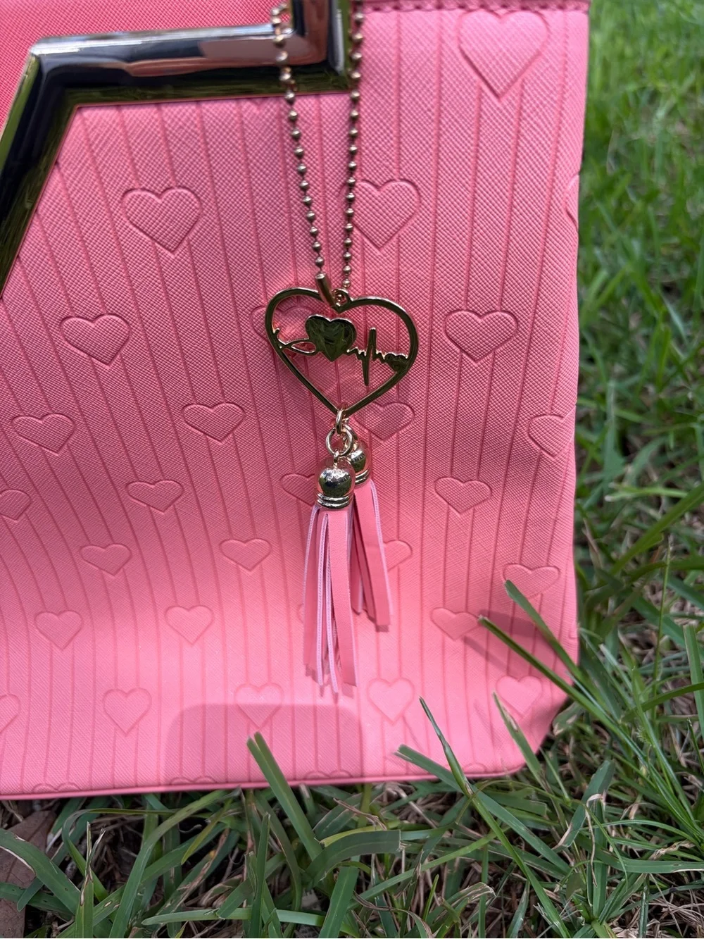 Crossi Pink Structured Heart-Embossed Tote Bag with Tassel Charm